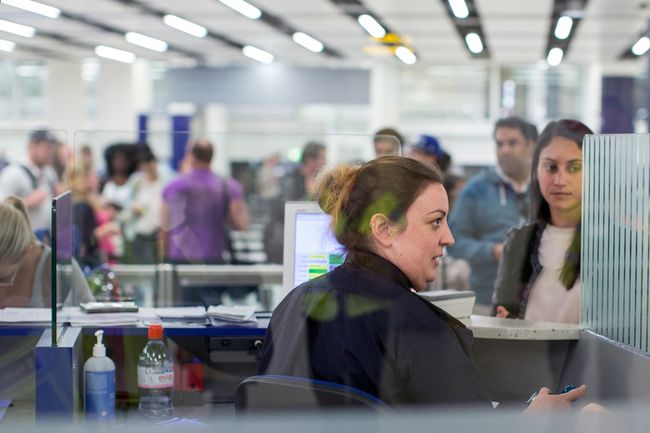Les forces frontalières vérifient les passeports des passagers arrivant à l'aéroport de Gatwick le 28 mai 2014 à Londres, en Angleterre.