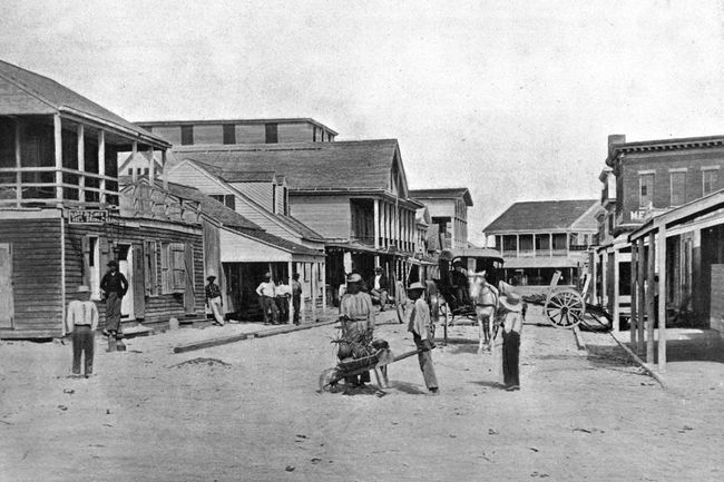 Rue de Key West, Floride, États-Unis, vers 1900. Bâtiments en bois et route non goudronnée.