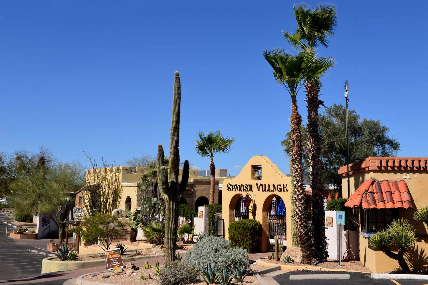 Entrée du village espagnol, une zone commerçante à la recherche d'une période à Carefree, Arizona, avec des cactus locaux et d'autres végétaux.